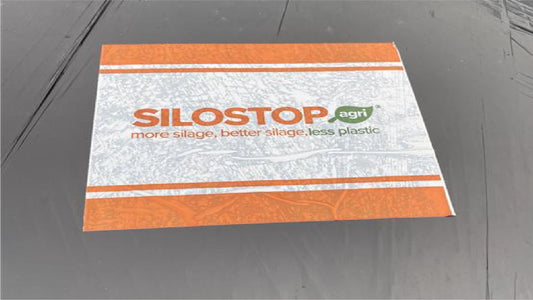 One sheet of Silostop Siloatch stuck to a black bale 